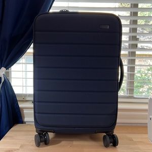 Away Expandable Carry-On Navy w front pocket.Hardside covered in canvas.